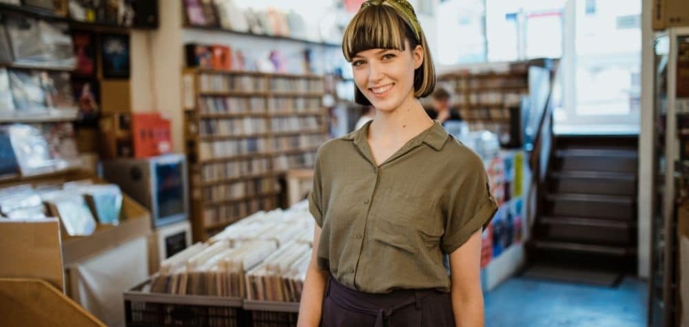 A Retail Worker Smiling because of all of the tax deductions she is going to claim